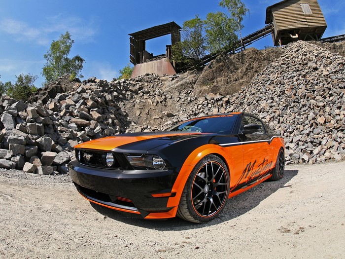 Orange and black Ford Mustang in a quarry