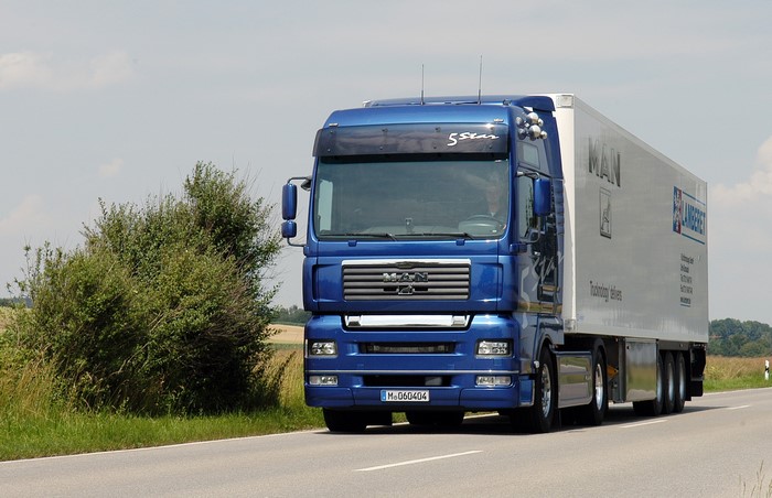 Blue MAN Truck with Trailer on Road