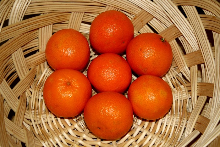 Seven mandarins in a woven basket