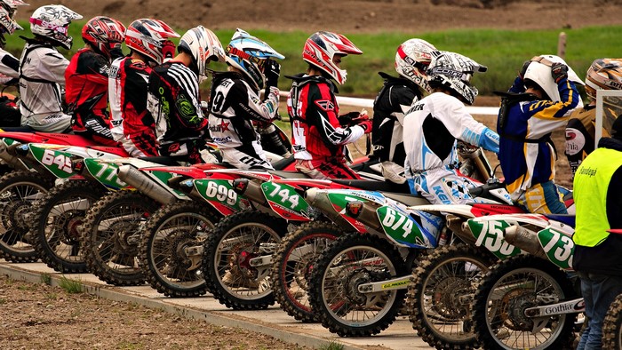 Motocross Racers Lined Up at Start Line