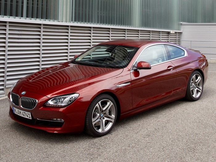 Red BMW 6 Series Coupe parked outside a modern building