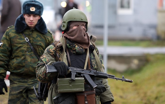 Two soldiers in camouflage uniforms and tactical gear