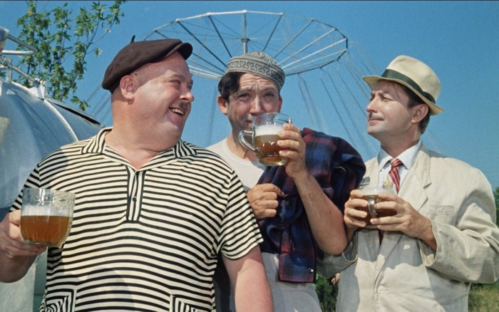 Three men drinking beer outdoors
