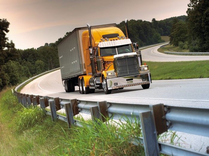 Yellow Western Star Truck on a Winding Road