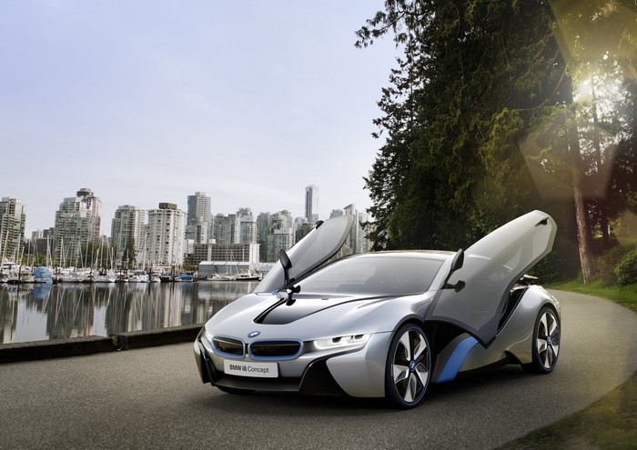 BMW i8 Concept car parked by a harbor with city skyline