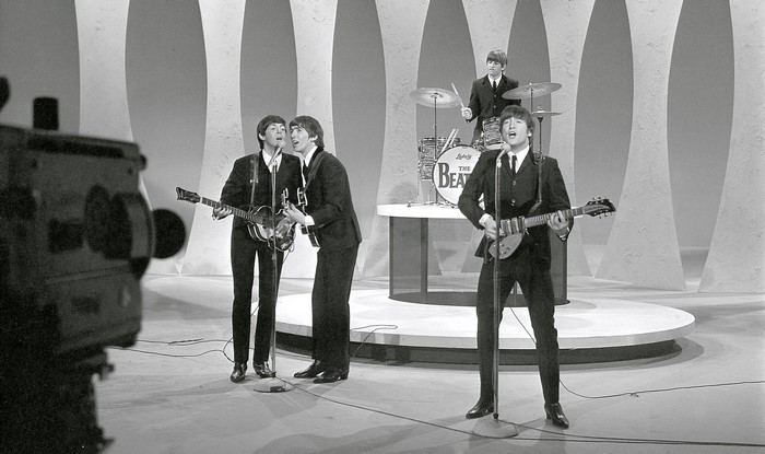 The Beatles performing on stage