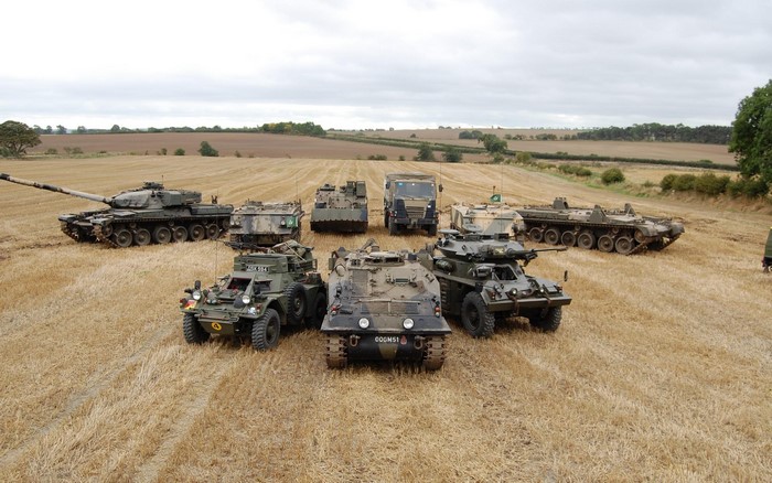Military vehicles parked in a field