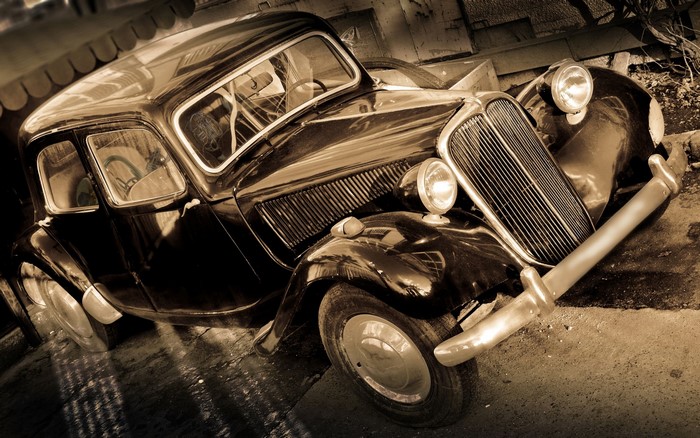 Sepia toned vintage car parked outdoors