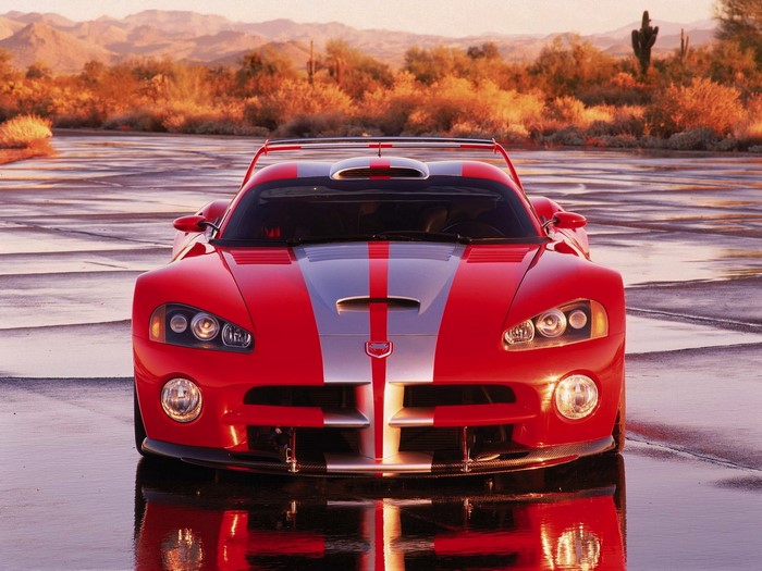 Red Dodge Viper with Silver Stripes on Wet Road