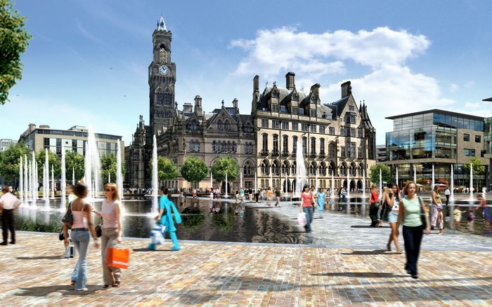 People in a plaza with fountains and historic buildings