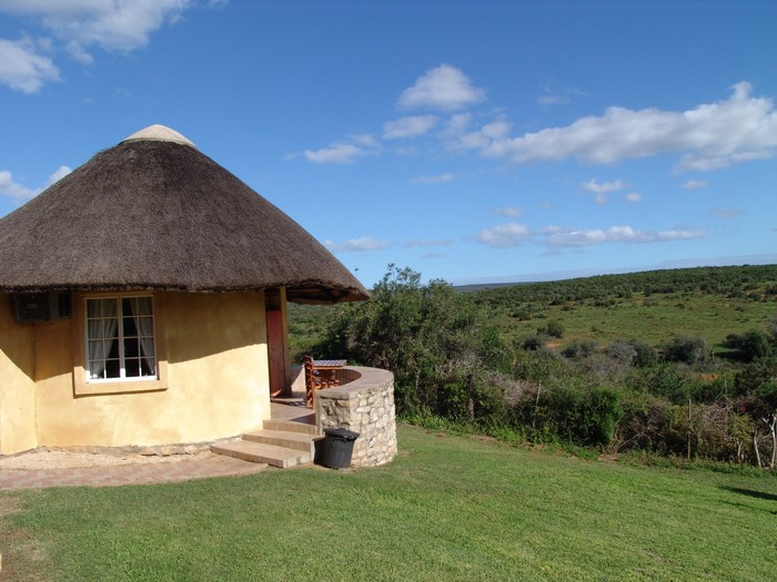 Thatched roof bungalow in South African landscape