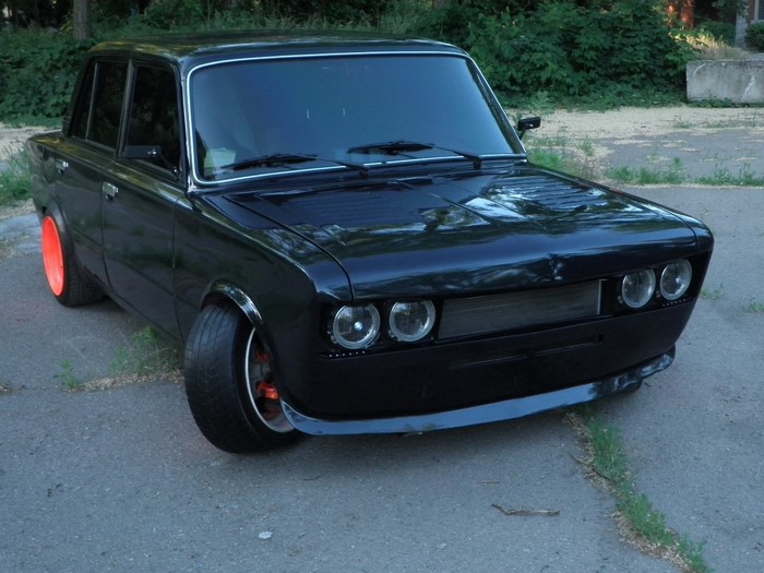 Black modified sedan with orange rims