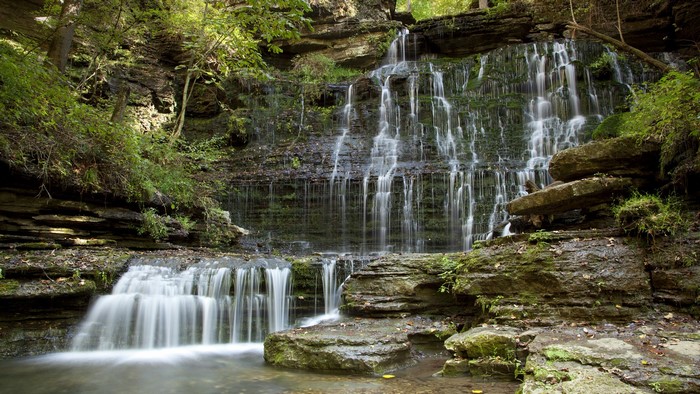 Waterfall cascading over mossy rocks in a forest