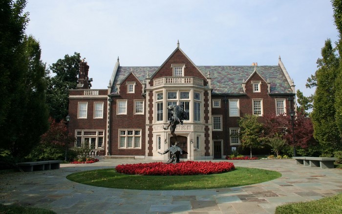 Brick Mansion with Sculpture and Flower Bed