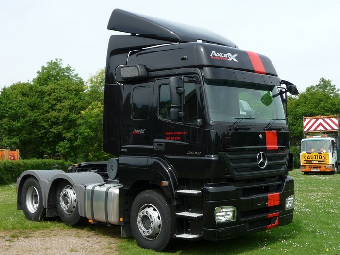 Black Mercedes-Benz Axor truck with red stripes