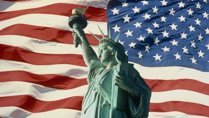Statue of Liberty in front of American Flag