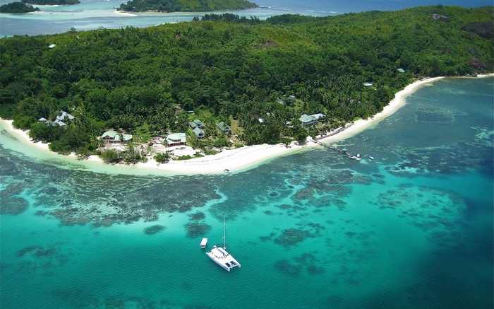 Aerial view of a tropical island with a catamaran