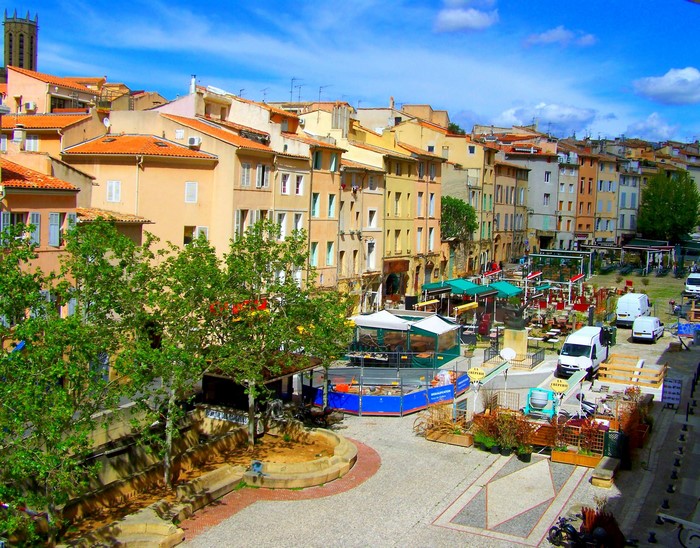 Town square with colorful buildings and market stalls