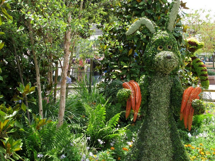 Topiary Rabbit holding carrots in a garden