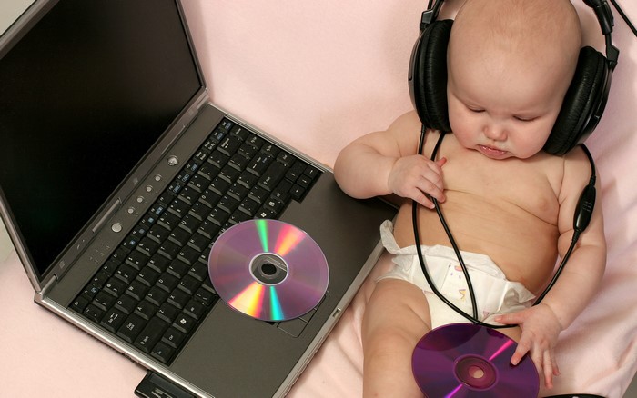 Baby with headphones and laptop