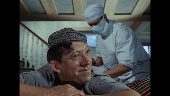 Man in cap looking at doctor in mask