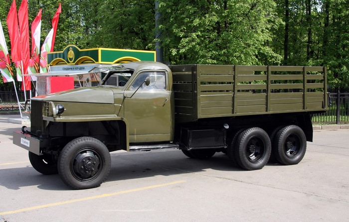 Green Studebaker truck with wooden bed