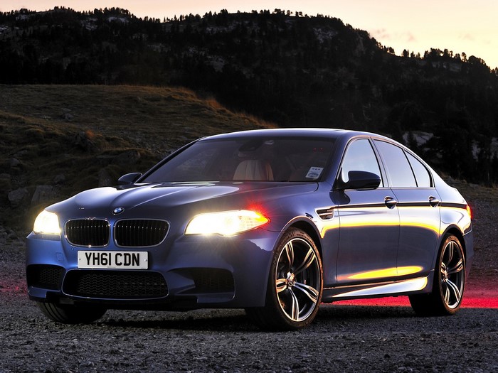 Blue BMW M5 Sedan on Gravel Road