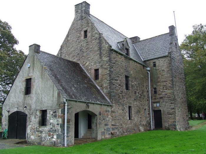 Stone castle with slate roof and attached garage