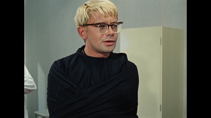 Man in straitjacket with glasses