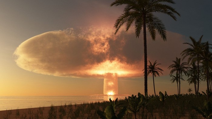 Nuclear explosion over the ocean at sunset