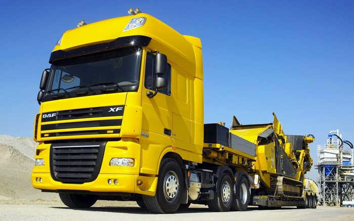 Yellow DAF XF Truck with Heavy Machinery