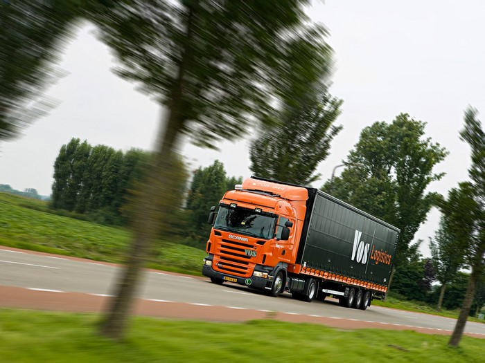 Orange Scania Truck with Vos Logistics Trailer on Road