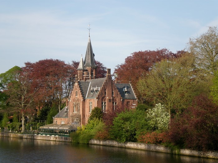 Castle by a canal in Bruges, Belgium