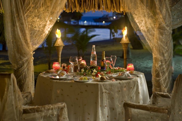 Romantic beach dinner setup at night