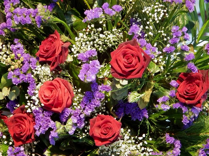 Bouquet of red roses and purple flowers