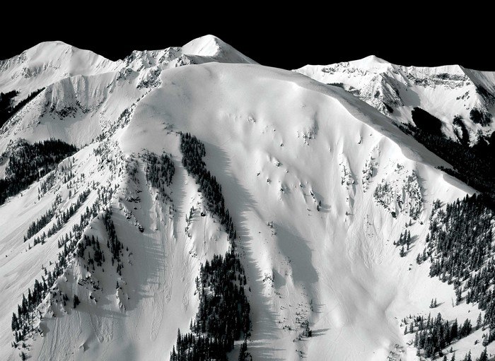Snow-covered mountains with pine trees