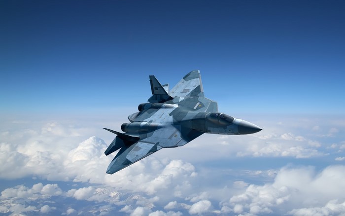 Sukhoi Su-57 fighter jet flying above clouds