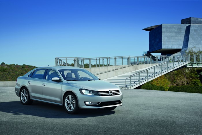 Silver Volkswagen sedan parked near a modern building