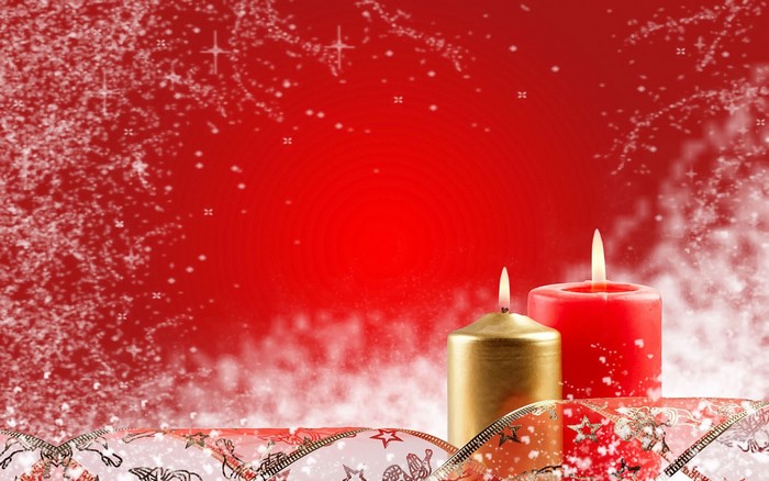 Christmas candles with ribbon and snow