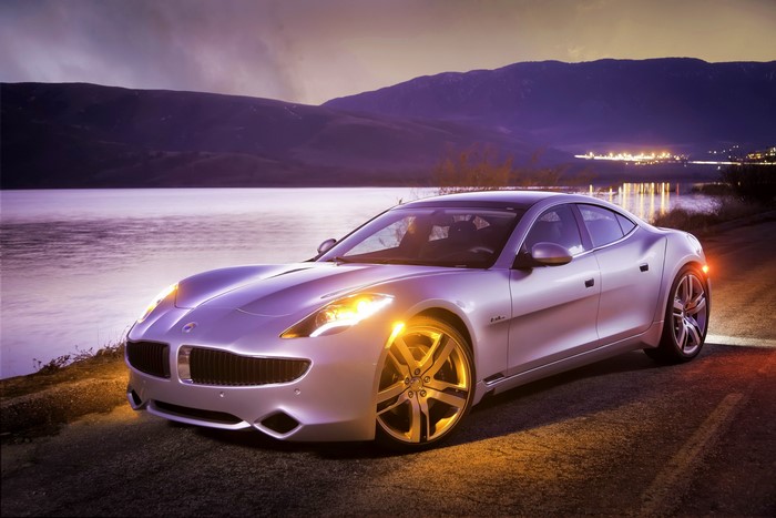 Fisker Karma car by a lake at dusk