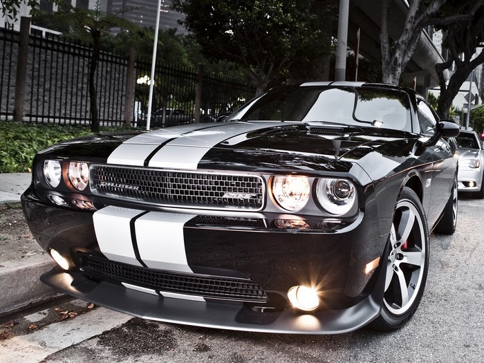 Black Dodge Challenger with white racing stripes