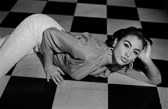 Monica Bellucci posing on a checkered floor