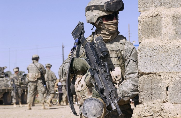 Soldiers in tactical gear with rifles