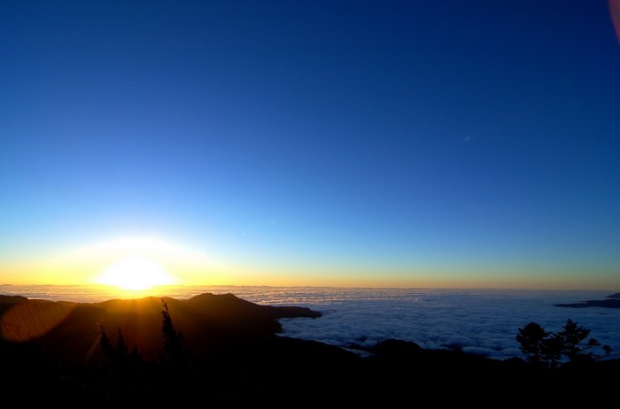Sunrise over clouds from mountain peak