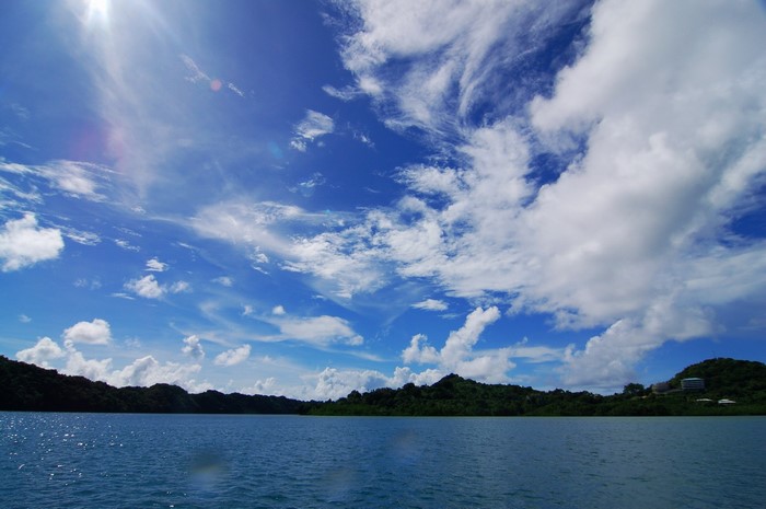Blue sky with clouds over a body of water and islands