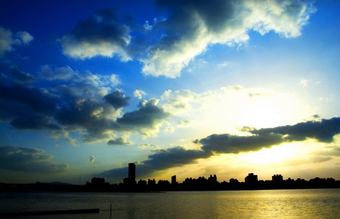 City skyline at sunset over water