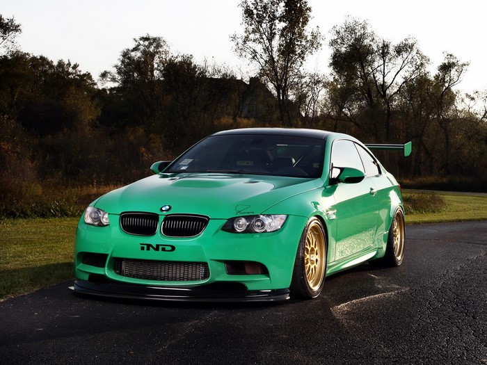 Green BMW M3 with a large rear spoiler