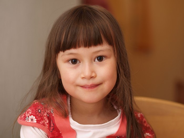 Young girl with bangs looking at the camera