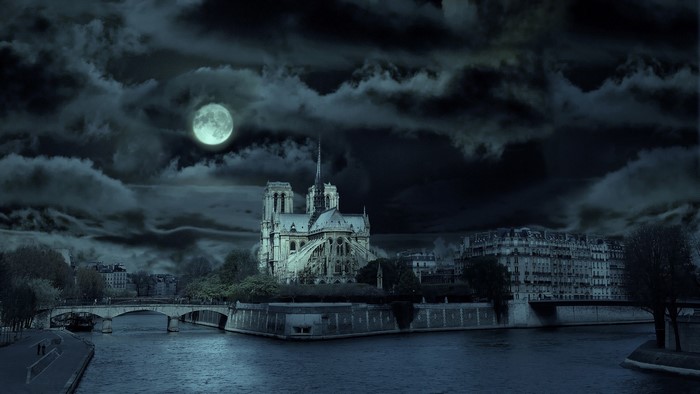 Notre Dame Cathedral in Paris at night under the moon