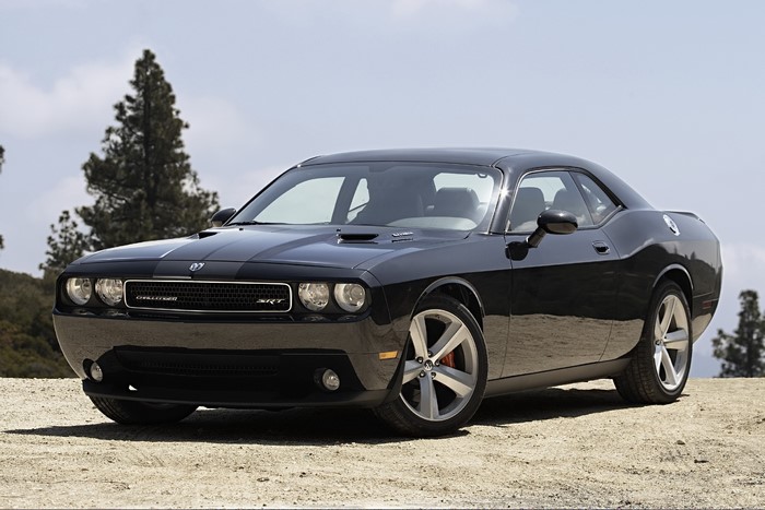 Black Dodge Challenger SRT parked on dirt